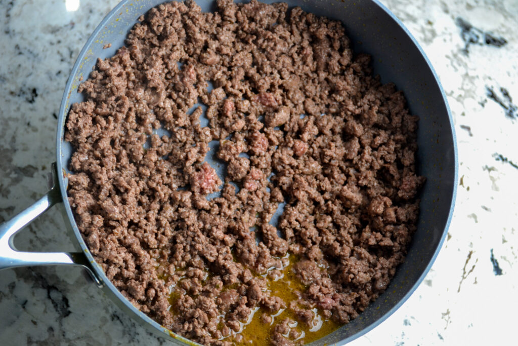 Browned ground beef in a large pot, ready for the taco soup seasonings