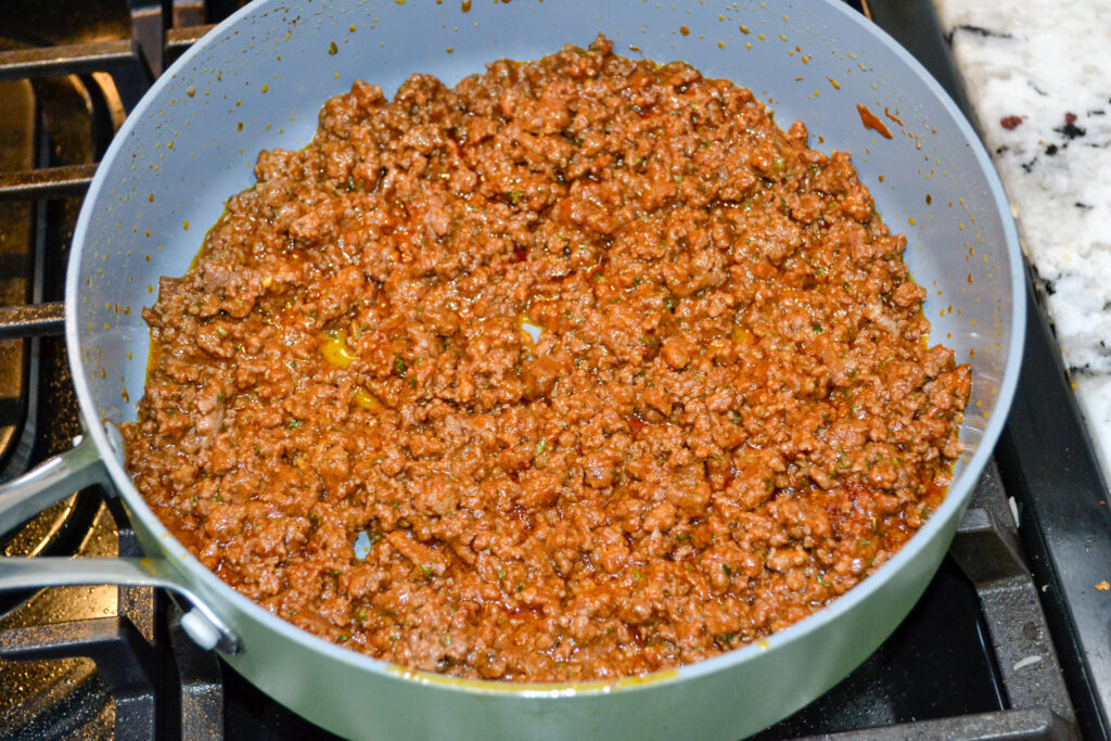 Ground beef stirred with taco and ranch seasoning in a large pot