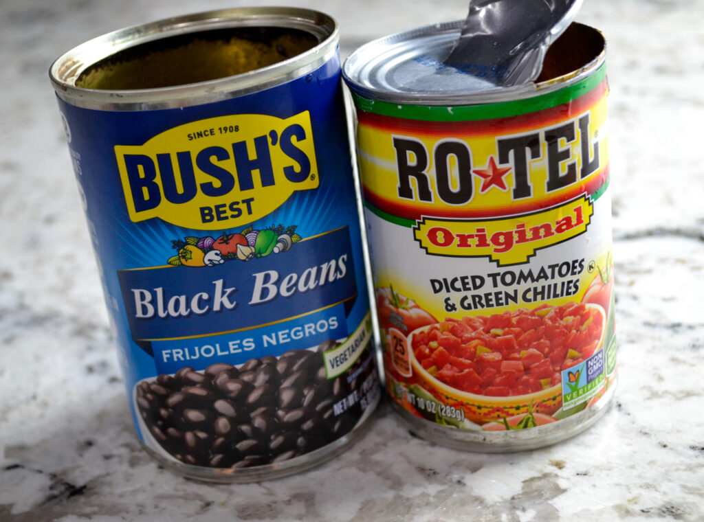 Cans of black beans and diced tomatoes with green chiles for taco soup