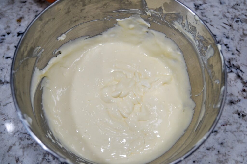 Smooth, creamy cheesecake filling in a mixing bowl